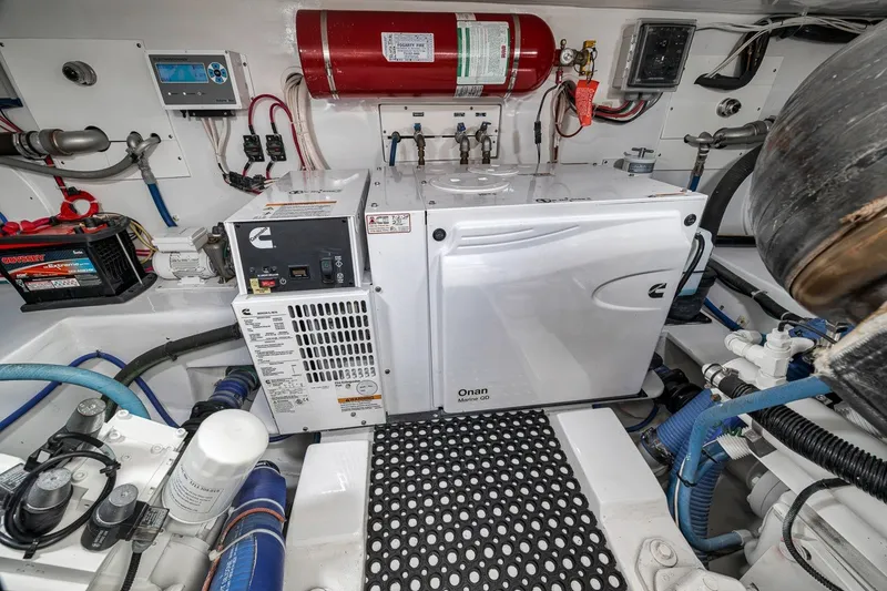 Slide: The Image of Engine room of 2025 Release Boatworks 46 Express with Onan generator and fire suppression system. - 43