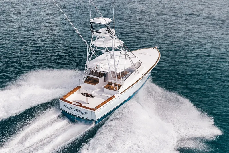 Slide: The Image of 2025 Release Boatworks 46 Express cruising on open water, showcasing sleek design and performance. - 20