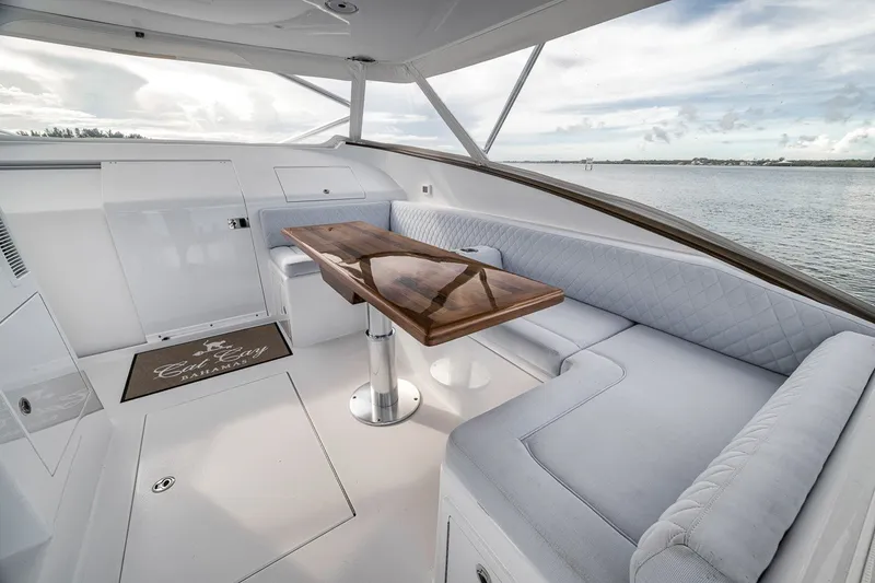 Slide: The Image of Luxurious interior of 2025 Release Boatworks 46 Express yacht with elegant seating and wooden table. - 61