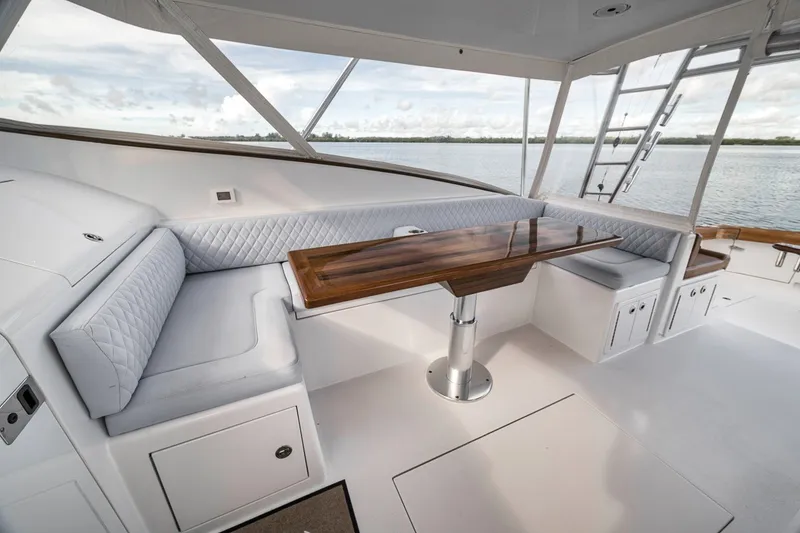 Slide: The Image of Luxurious interior of 2025 Release Boatworks 46 Express with elegant seating and wooden table. - 62