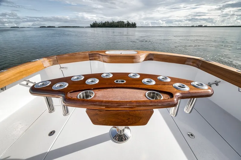 Slide: The Image of Sleek 2025 Release Boatworks 46 Express with polished wood and chrome accents on deck. - 50