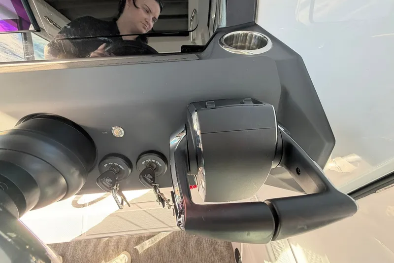 Slide: The Image of 2025 Axopar 29 XC Cross Cabin dashboard with controls and cup holder. - 19