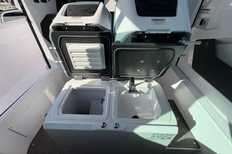 Slide: The Image of 2025 Axopar 29 XC Cross Cabin interior with open storage compartments. - 20