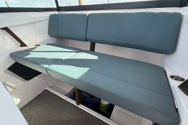 Slide: The Image of 2025 Axopar 29 XC Cross Cabin interior seating with blue cushions. - 23