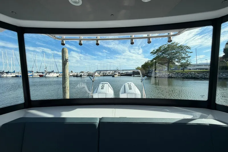 Slide: The Image of View from inside a 2025 Axopar 29 XC Cross Cabin, overlooking marina and water. - 28