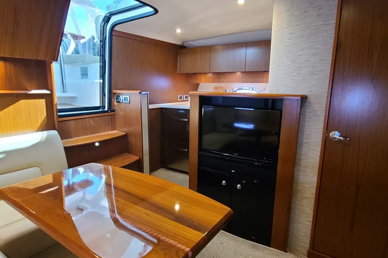 Slide: The Image of Interior of a 2016 Tiara Yachts 3900 Coronet with wood finishes and modern amenities. - 24