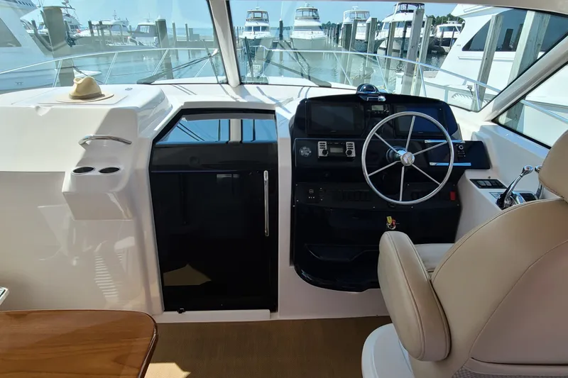 Slide: The Image of Helm of 2016 Tiara Yachts 3900 Coronet with steering wheel and navigation controls. - 5