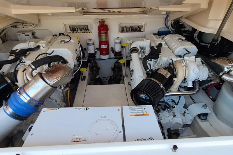 Slide: The Image of Engine room of 2016 Tiara Yachts 3900 Coronet, featuring dual engines and fire extinguisher. - 28