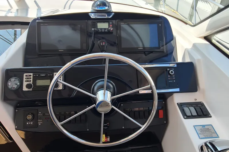 Slide: The Image of Helm of 2016 Tiara Yachts 3900 Coronet with dual Garmin displays and steering wheel. - 4