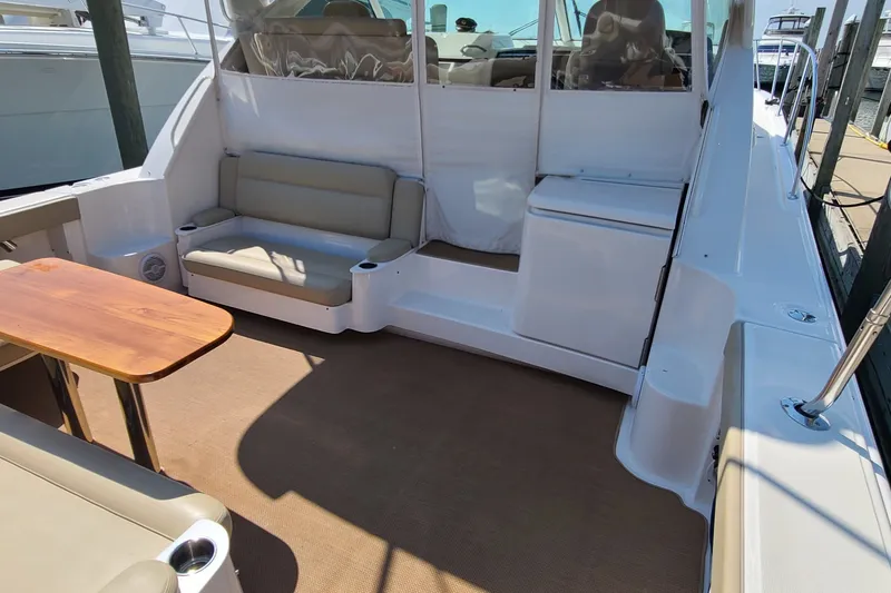 Slide: The Image of 2016 Tiara Yachts 3900 Coronet interior with seating and wooden table. - 10