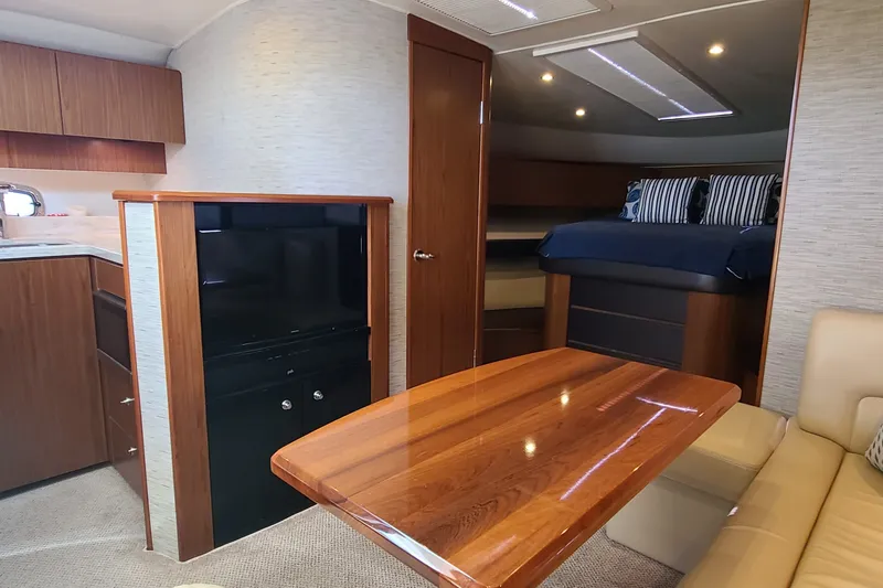 Slide: The Image of Interior of 2016 Tiara Yachts 3900 Coronet with wood finishes and cozy seating area. - 25