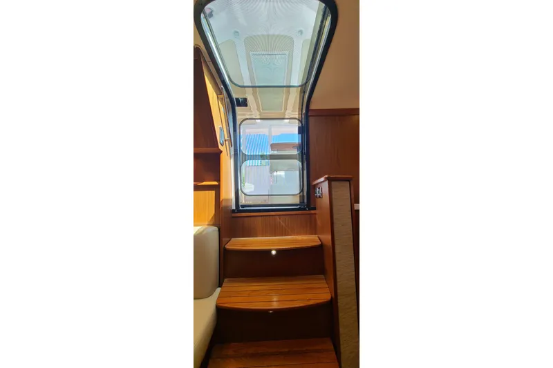 Slide: The Image of Interior stairs of 2016 Tiara Yachts 3900 Coronet with wooden finish. - 22