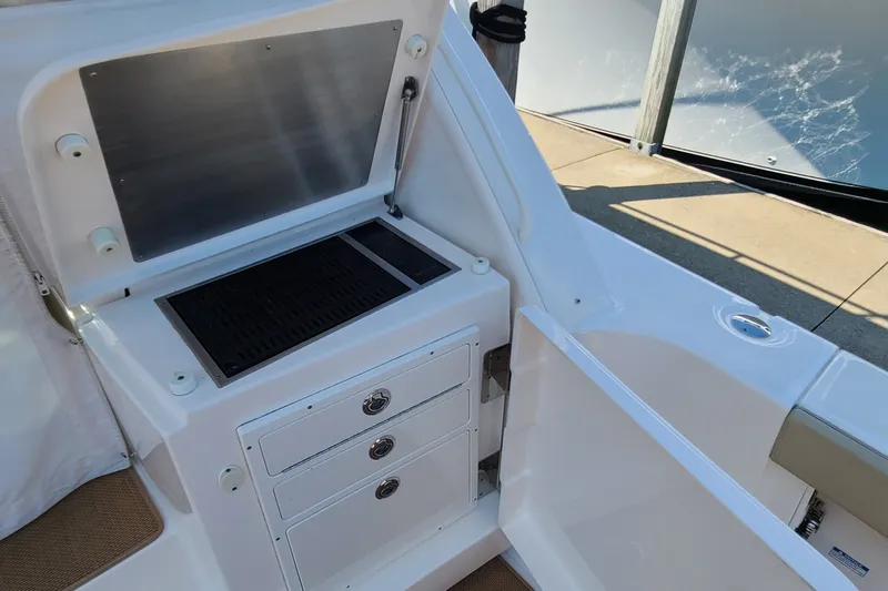 Slide: The Image of Outdoor kitchen area on 2016 Tiara Yachts 3900 Coronet with grill and storage drawers. - 12