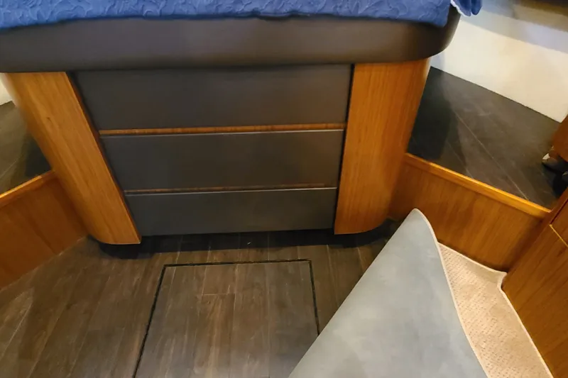 Slide: The Image of Interior of 2016 Tiara Yachts 3900 Coronet with wood accents and storage drawers. - 19