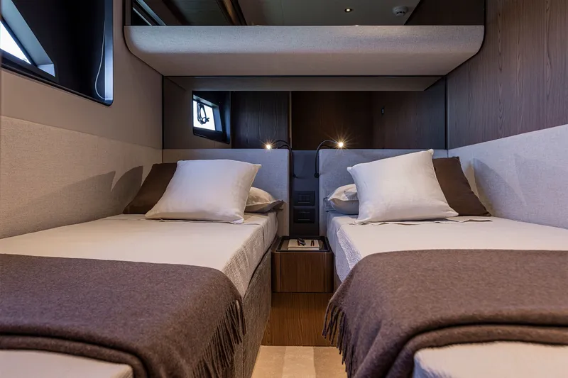 Slide: The Image of Luxurious twin cabin interior of 2025 Ferretti Yachts 580, featuring elegant bedding and modern design. - 41