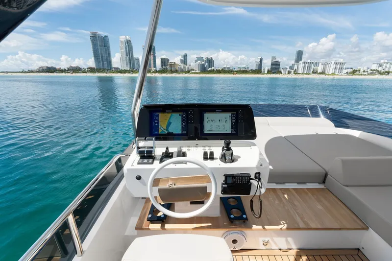 Slide: The Image of Cockpit view of 2025 Ferretti Yachts 580 with city skyline in background. - 27