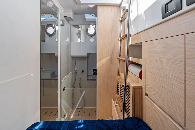 Slide: The Image of Interior of 2025 Ferretti Yachts 580, featuring modern wood finishes and compact bathroom. - 69