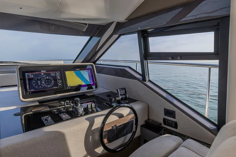 Slide: The Image of Helm of 2025 Ferretti Yachts 580 with advanced navigation displays and ocean view. - 23