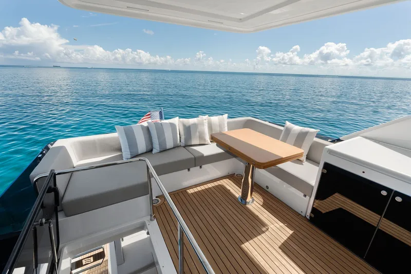 Slide: The Image of Luxurious 2025 Ferretti Yachts 580 deck with ocean view and elegant seating area. - 30