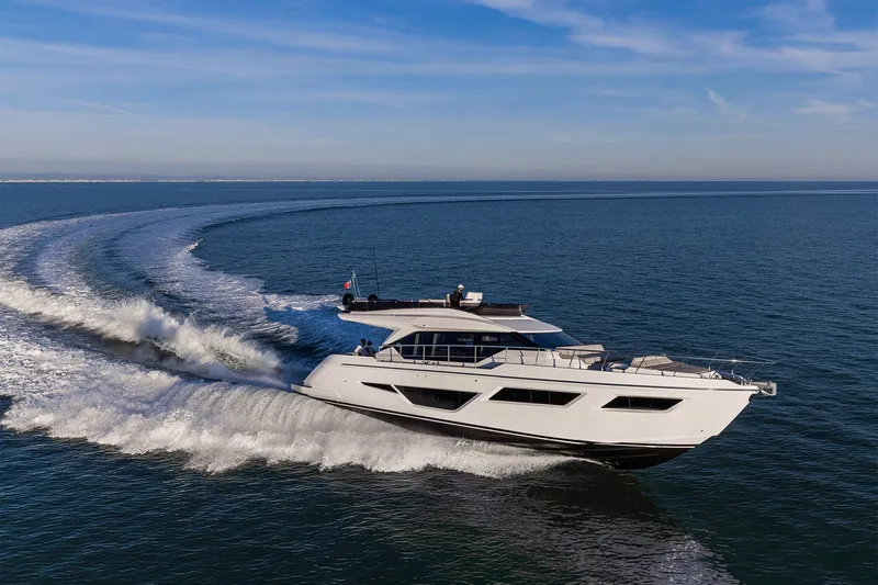 The Image of 2025 Ferretti Yachts 580 cruising on open sea under clear blue sky. - 2