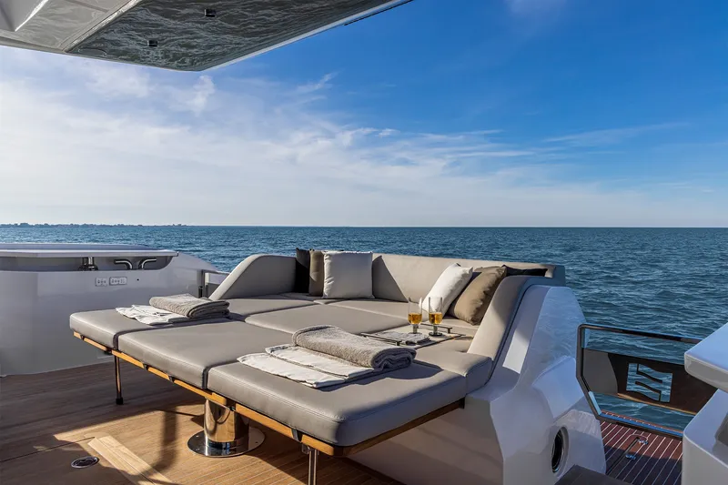 Slide: The Image of Luxurious 2025 Ferretti Yachts 580 deck with sun loungers and ocean view. - 15