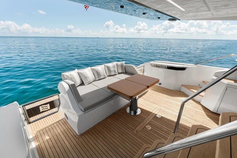 Slide: The Image of Luxurious 2025 Ferretti Yachts 580 deck with elegant seating and ocean view. - 21