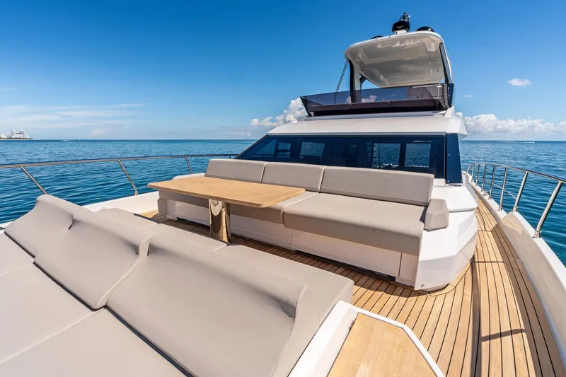 Slide: The Image of Luxurious 2025 Ferretti Yachts 580 with spacious deck and seating, cruising on open sea. - 16