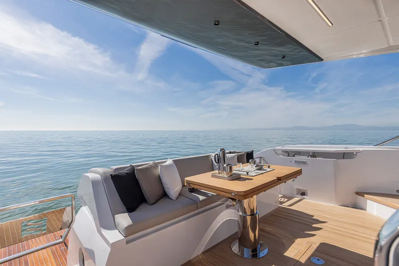 Slide: The Image of Luxurious 2025 Ferretti Yachts 580 deck with elegant seating and ocean view. - 13