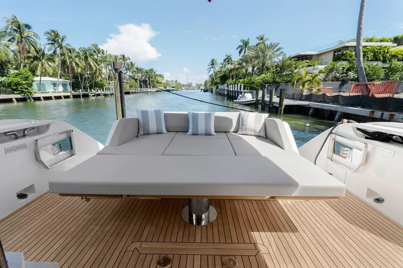 Slide: The Image of Luxurious 2025 Ferretti Yachts 580 deck with plush seating, overlooking serene waterfront. - 33