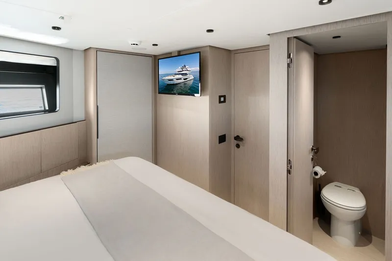 Slide: The Image of Luxurious interior of 2025 Ferretti Yachts 580, featuring a modern bedroom and ensuite bathroom. - 60