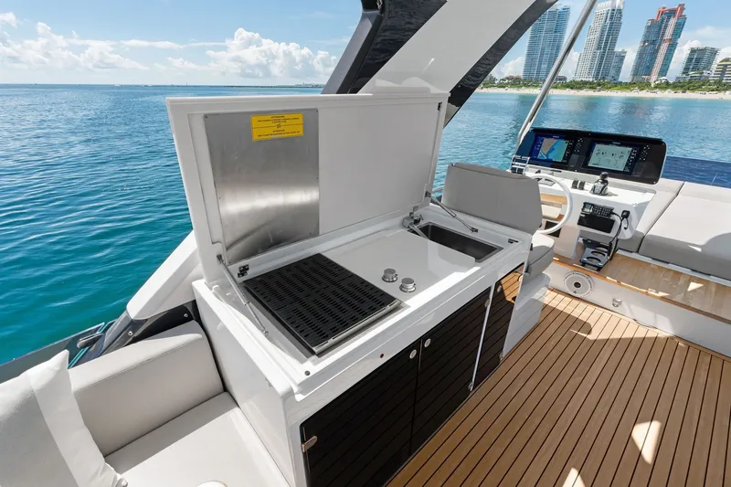 Slide: The Image of Luxurious 2025 Ferretti Yachts 580 with sleek outdoor kitchen and stunning ocean view. - 32