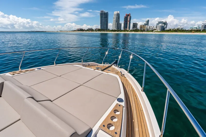 Slide: The Image of Luxurious 2025 Ferretti Yachts 580 cruising near a city skyline on a sunny day. - 18