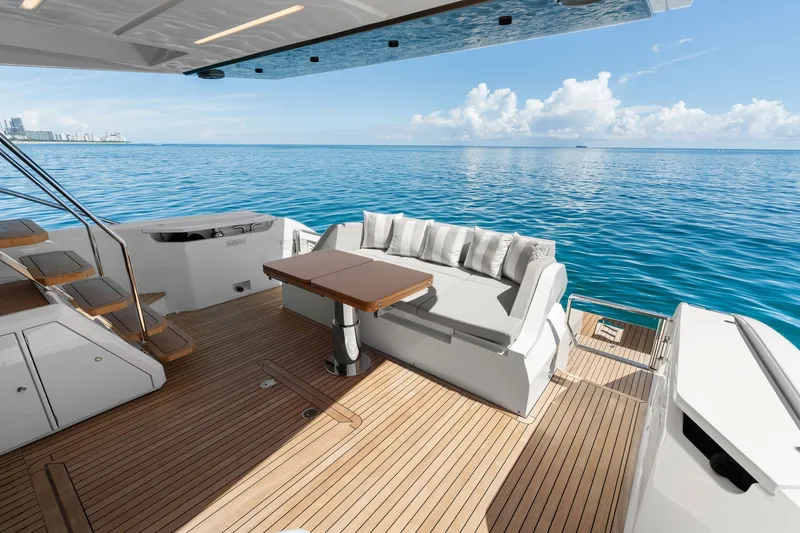 Slide: The Image of Luxurious 2025 Ferretti Yachts 580 deck with ocean view and elegant seating area. - 23