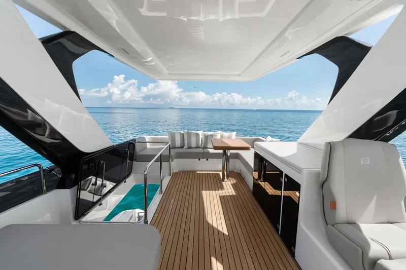 Slide: The Image of Luxurious 2025 Ferretti Yachts 580 interior with ocean view, featuring sleek design and comfortable seating. - 28