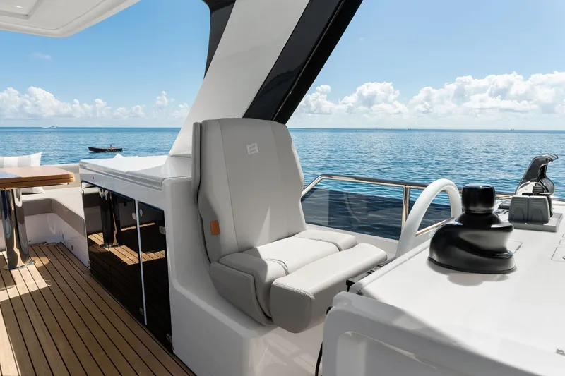 Slide: The Image of Luxurious 2025 Ferretti Yachts 580 interior with ocean view and modern helm station. - 26