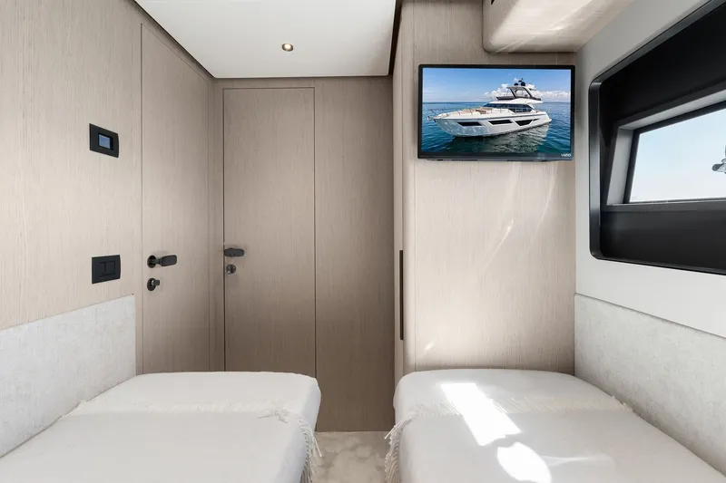 Slide: The Image of Interior cabin of 2025 Ferretti Yachts 580 with twin beds and wall-mounted TV. - 67