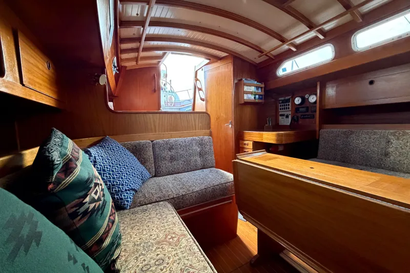Slide: The Image of Cozy interior of 1987 Vindo 45 sailboat with wooden furnishings and patterned cushions. - 49
