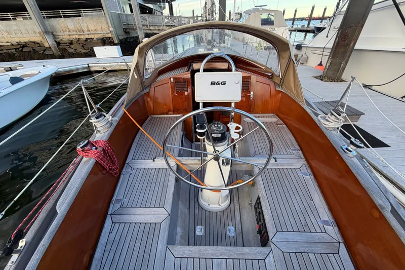 Slide: The Image of 1987 Vindo 45 sailboat cockpit with wooden deck and steering wheel at marina. - 21