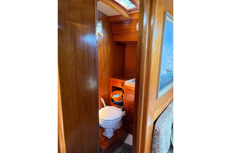 Slide: The Image of Wooden interior of 1987 Vindo 45 yacht featuring compact bathroom with toilet. - 39