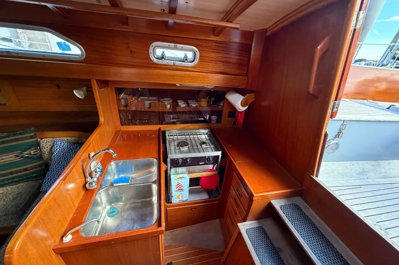 Slide: The Image of Cozy 1987 Vindo 45 yacht interior with wooden kitchen and compact amenities. - 29