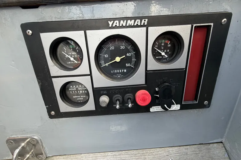 Slide: The Image of Yanmar engine control panel on a 1987 Vindo 45 sailboat, featuring gauges and switches. - 25