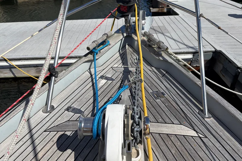 Slide: The Image of Bow of 1987 Vindo 45 sailboat with ropes and anchor chain at dock. - 14