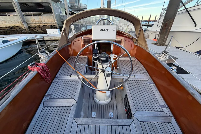 Slide: The Image of Cockpit of a 1987 Vindo 45 sailboat with wooden deck and steering wheel. - 23
