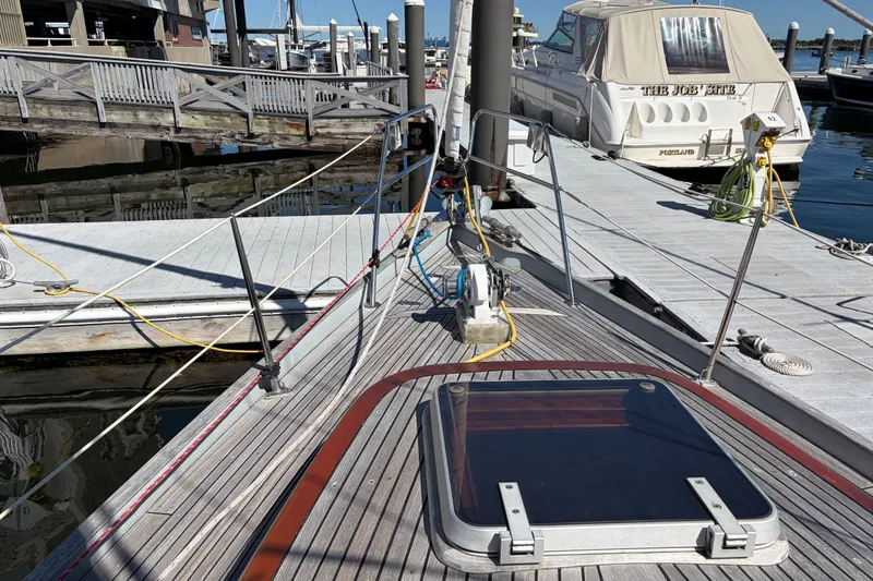 Slide: The Image of Sailboat Vindo 45, 1987 model, docked at marina with visible deck and hatch. - 13