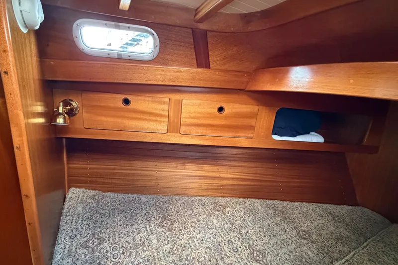 Slide: The Image of Cozy wooden cabin interior of 1987 Vindo 45 sailboat with storage and bedding. - 47