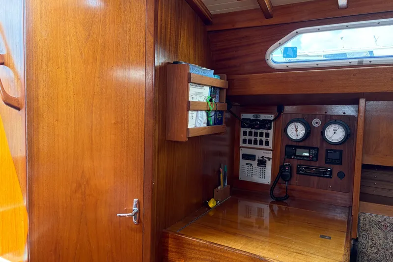 Slide: The Image of Interior of 1987 Vindo 45 sailboat with wooden paneling and navigation instruments. - 32