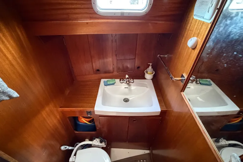 Slide: The Image of 1987 Vindo 45 yacht bathroom with wooden interior, sink, and mirror. - 41