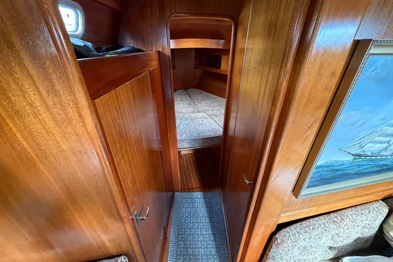 Slide: The Image of Cozy wooden interior of 1987 Vindo 45 sailboat cabin with bed and nautical painting. - 38