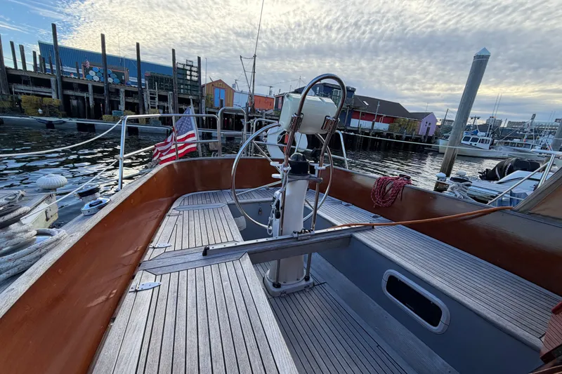 Slide: The Image of Sailboat Vindo 45, 1987 model, docked at a marina with American flag. - 18