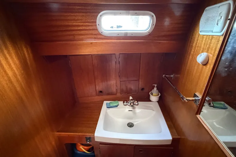 Slide: The Image of Wooden bathroom interior of 1987 Vindo 45 yacht with sink and mirror. - 40